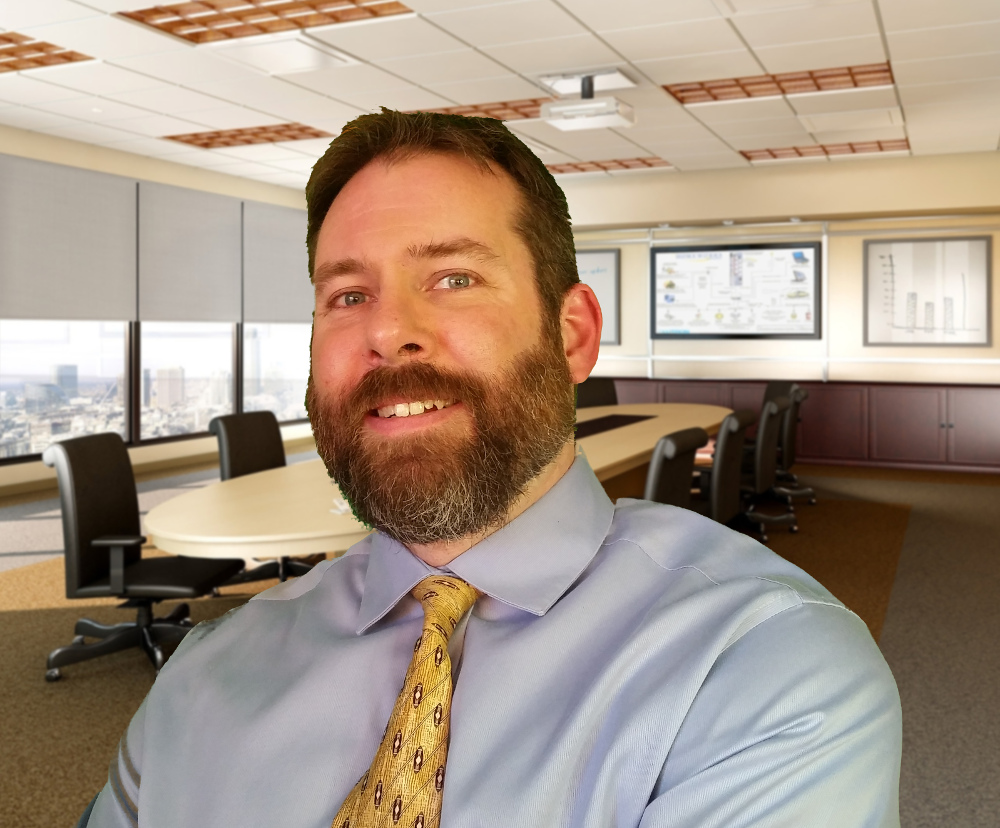 Professional headshot of Marc J Gilbert in yellow tie
