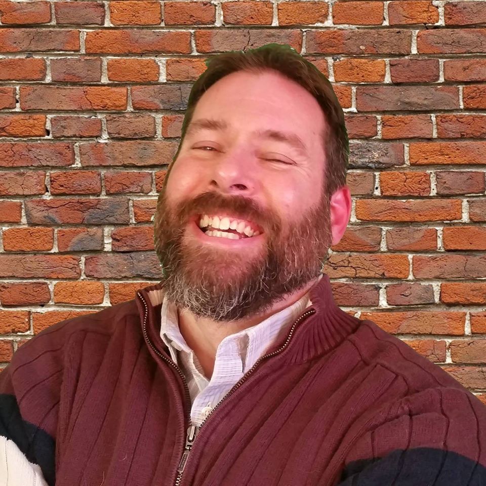 Marc J
            Gilbert laughing against brick wall